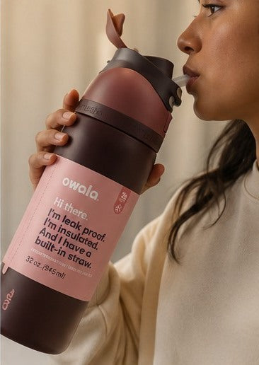 Maroon insulated water bottle being used for sipping