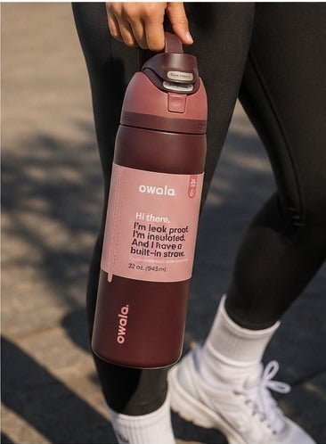 Maroon insulated water bottle carried outdoors