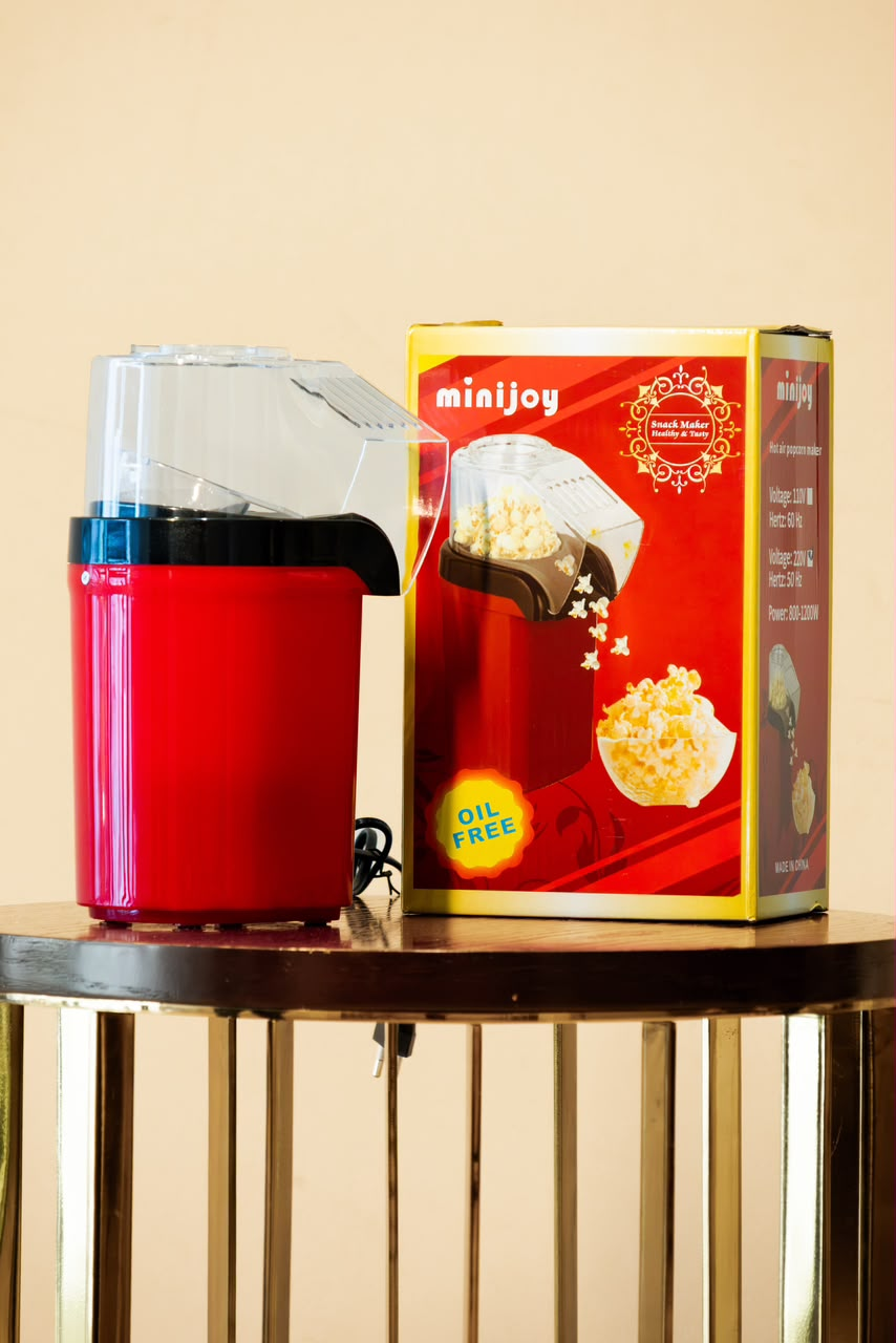 Red oil-free popcorn maker and retail box from an alternate angle